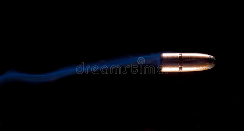 Bullet and blue smoke behind royalty free stock photos
