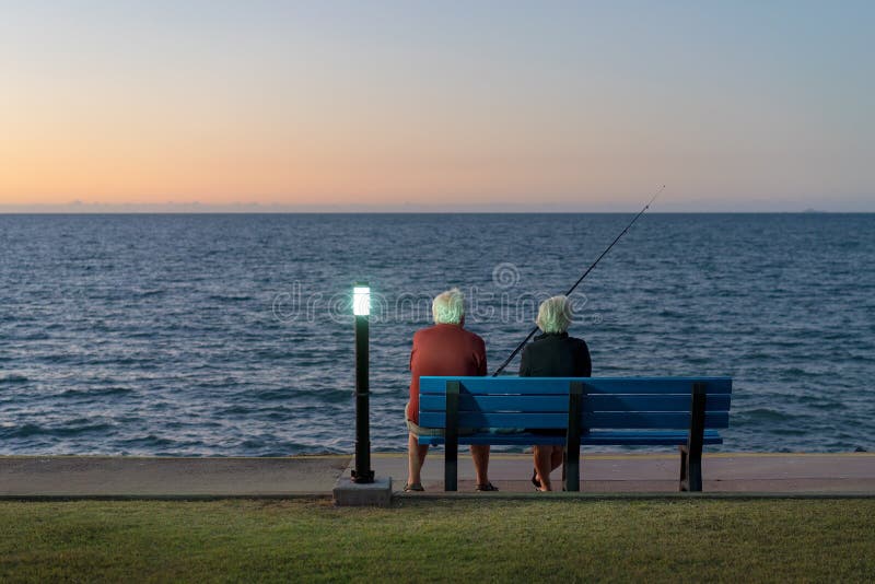 Coppie anziane che si siedono su una pesca del banco fotografia stock libera da diritti Coppie anziane che si siedono su una pesca del banco fotografia stock libera da diritti