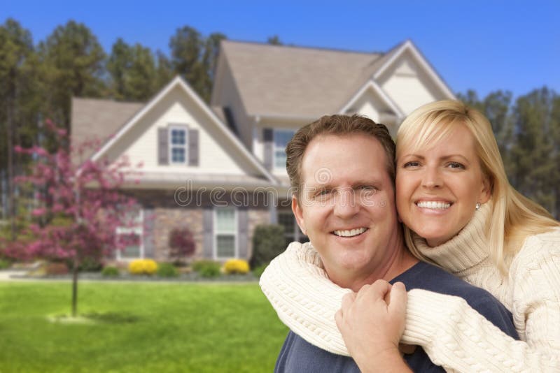 Happy Couple Hugging in Front of Beautiful House. Happy Couple Hugging in Front of Beautiful House.