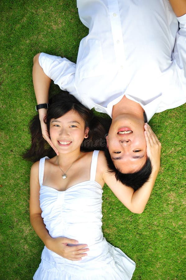 Asian Couple In Love Spending Time In The Park. Asian Couple In Love Spending Time In The Park