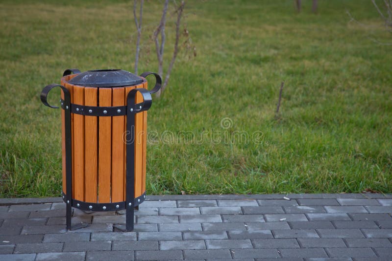 Copy Space on the Left. Rubbish Box in the Park . a Wooden Urn and a