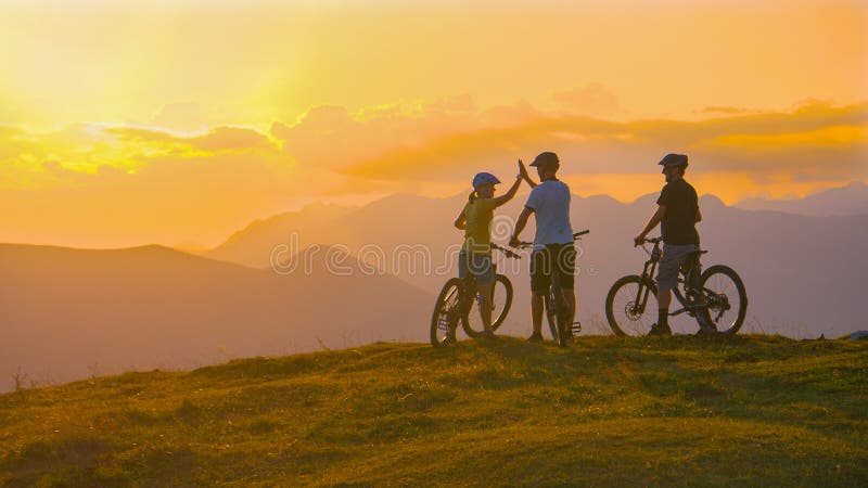 COPY SPACE: Three friends celebrate a cross country bike trip on a sunny evening