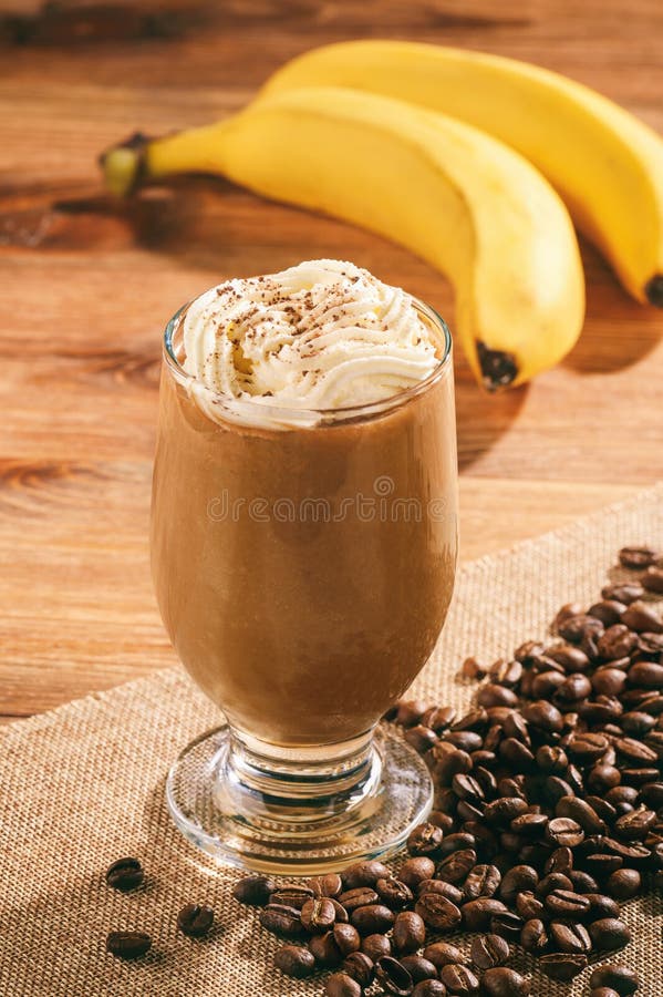 Coquetel de leite de café com banana em fundo de madeira fotografia de stock