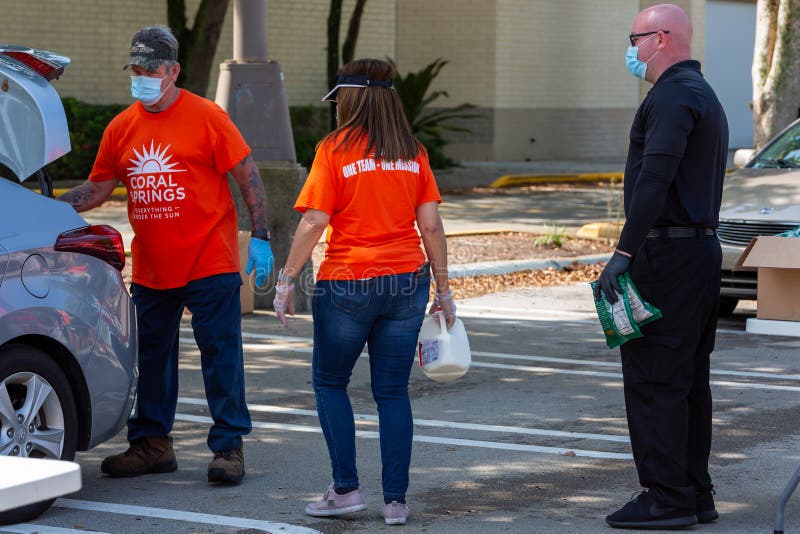 One Team - One Mission, Food Distribution with Coral Springs Police Department officers and Coral Springs Fire Department royalty free stock images One Team - One Mission, Food Distribution with Coral Springs Police Department officers and Coral Springs Fire Department royalty free stock images