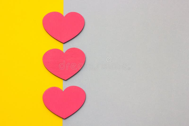 Wooden hearts on a multi-colored background, top view. Wooden hearts on a multi-colored background, top view