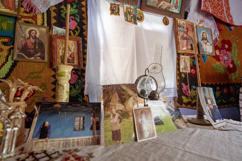 Corbi, Romania - July 2019: traditional peasants house interior well preserved with authentic carpets, clothing and personal items