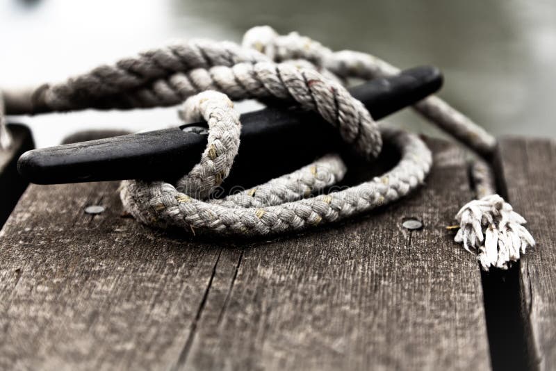 Close-up of nautical rope tied on a cleat. Close-up of nautical rope tied on a cleat.