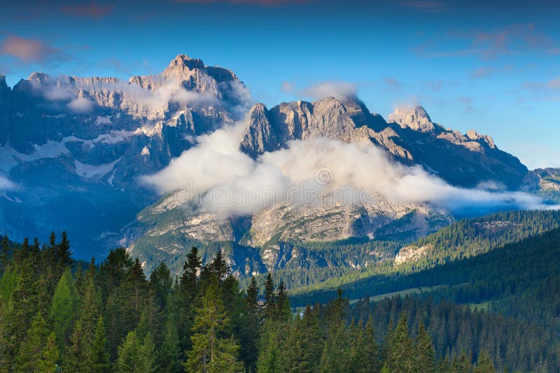 Gruppo Del Cristallo mountain range at foggy summer morning. Dolomites mountains, Italy, Europe. Gruppo Del Cristallo mountain range at foggy summer morning. Dolomites mountains, Italy, Europe.