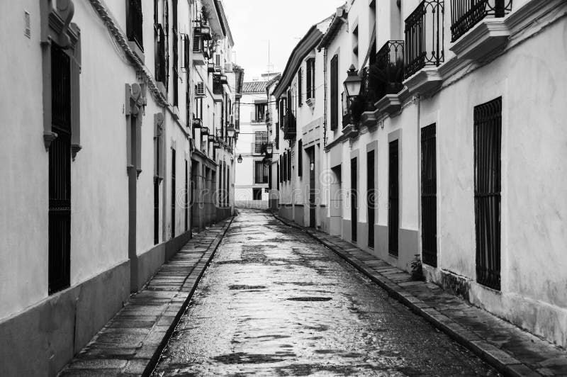 Streets of old city in Andalusia. Quiet empty street in Cordoba, Spain. Black and white stock image Streets of old city in Andalusia. Quiet empty street in Cordoba, Spain. Black and white stock image