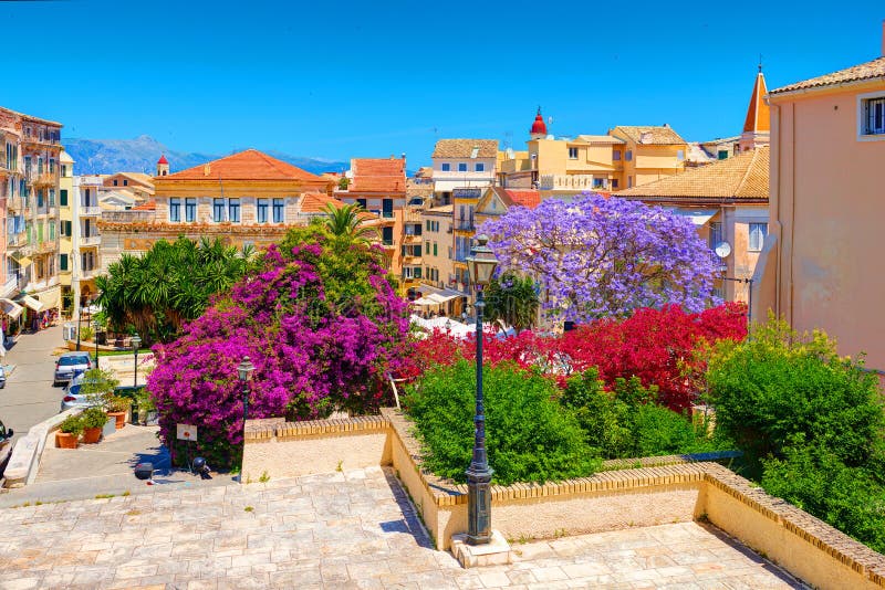 CORFU ISLAND, GREECE, JUN,06, 2014: Downtown garden park colorful trees flowers Greek old houses architecture of Greece Corfu isla stock photography CORFU ISLAND, GREECE, JUN,06, 2014: Downtown garden park colorful trees flowers Greek old houses architecture of Greece Corfu isla stock photography