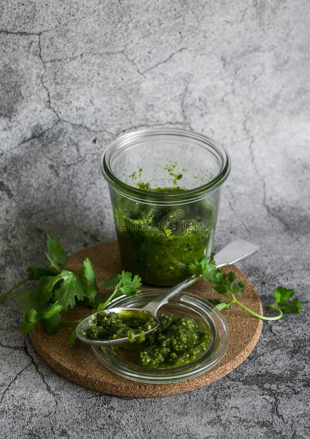 Coriander Pesto Sauce on a Grey Background, Top View. Delicious Sauce