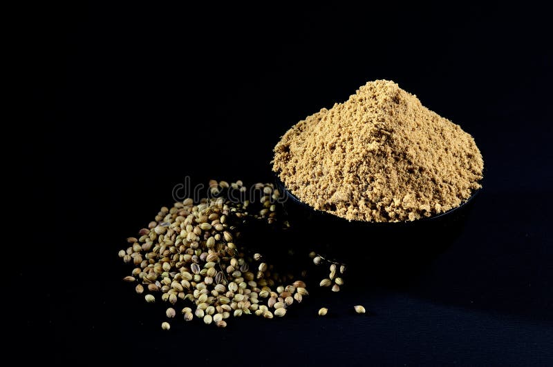 Coriander Powder and Coriander Seeds on Black Background Stock Photo