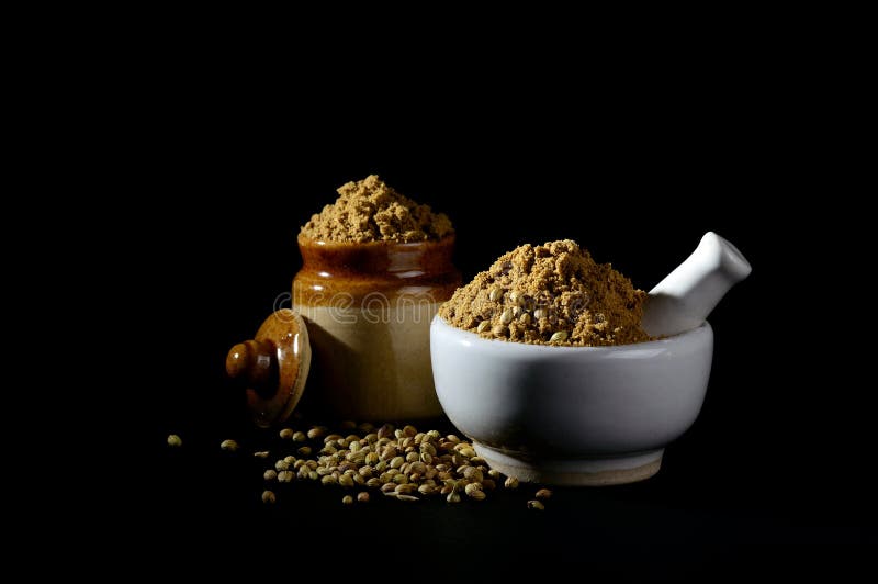 Coriander Powder and Coriander Seeds on Black Background Stock Photo
