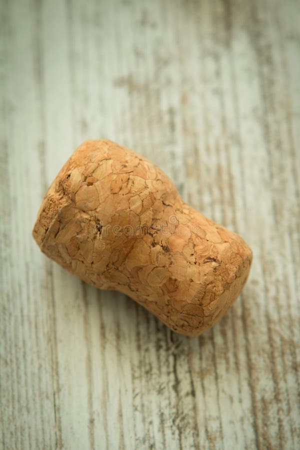 Cork from a champagne bottle on a wooden background.