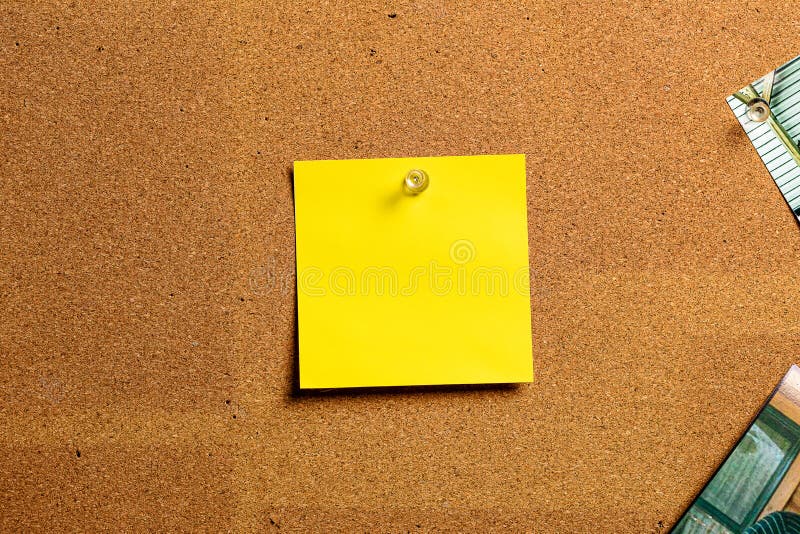 Corkboard/Bulletin Board with a Single Yellow Sticky Note Centered on