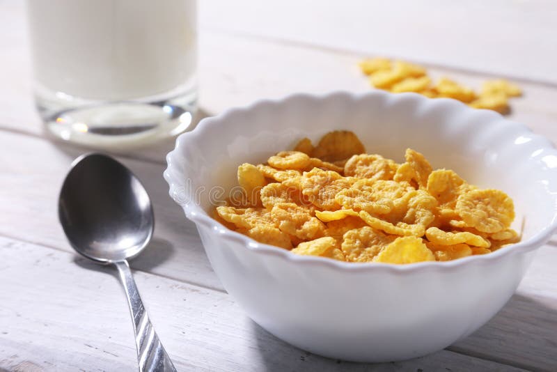 Corn Flakes Cereal in a Bowl and Glass with Milk. Morning Breakfast. Stock Photo Image of