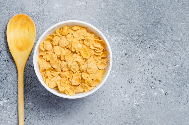 Corn Flakes in a Plate and a Wooden Spoon. Healthy Breakfast Stock