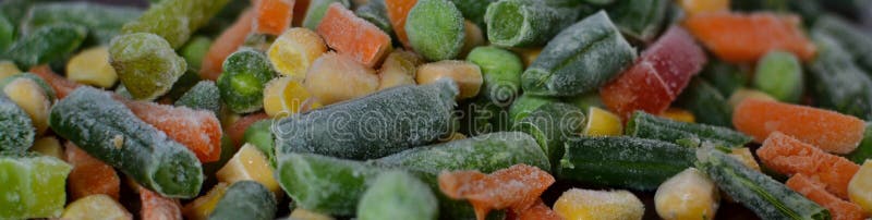 Corn, green beans, green peas, carrots, peppers and onions in hoarfrost