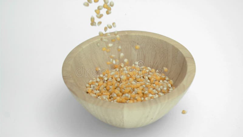 Corn Kernels in Super Slow Motion Falling in a Wooden Bowl Stock ...