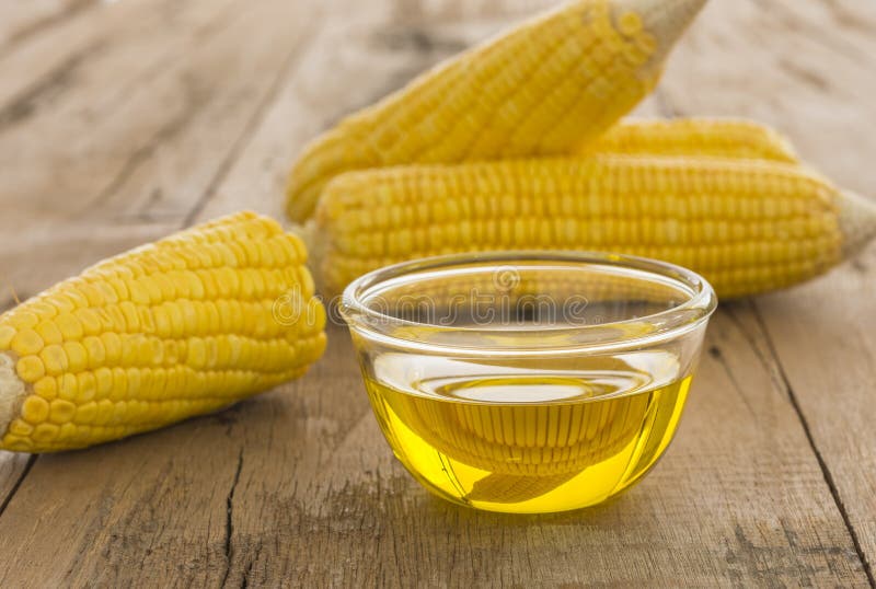Corn Essential Oil Bottle, Seeds In Bowl And Corncobs Stock Photo