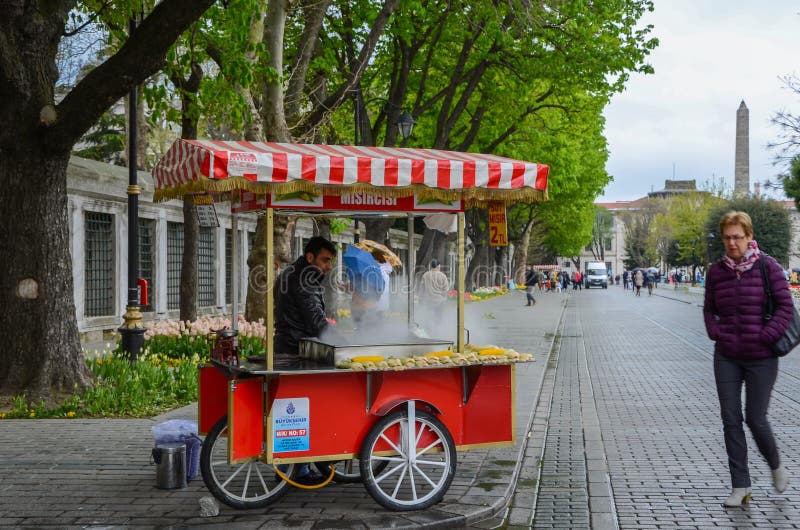ISTANBUL, TURKEY, 02 JUNE 2017: Seller boiled corn cart on Sultanahmet Square. ISTANBUL, TURKEY, 02 JUNE 2017: Seller boiled corn cart on Sultanahmet Square