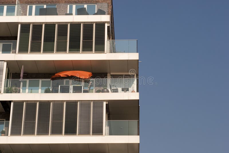 A Corner Apartment Building with Circular Round Balcony, Railings and