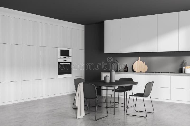 Corner of Minimalist Modern Grey Kitchen with Round Dining Table Stock