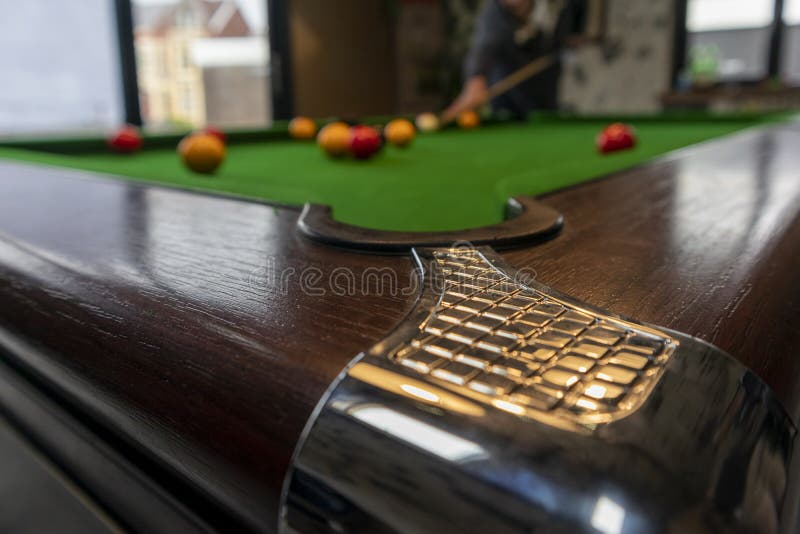 Corner Pocket of Pool Table, Blurred Game in Background. Stock Image