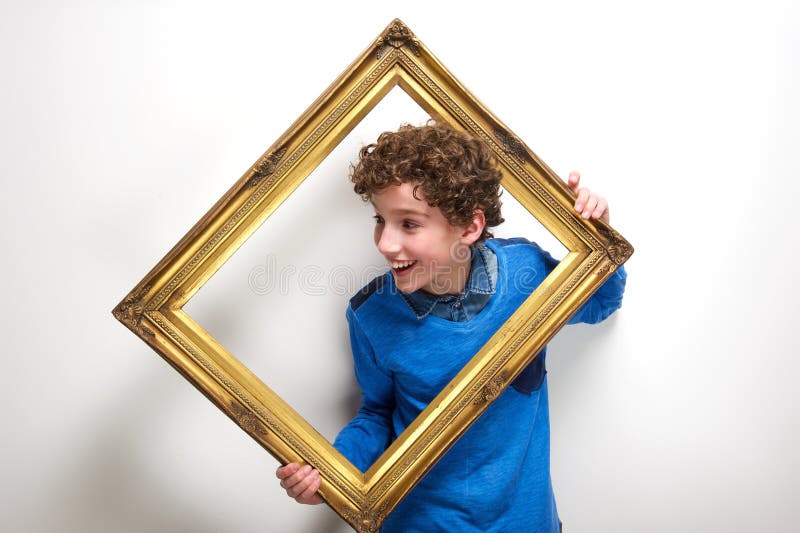 Cornice allegra della tenuta del ragazzino immagine stock libera da diritti Cornice allegra della tenuta del ragazzino immagine stock libera da diritti
