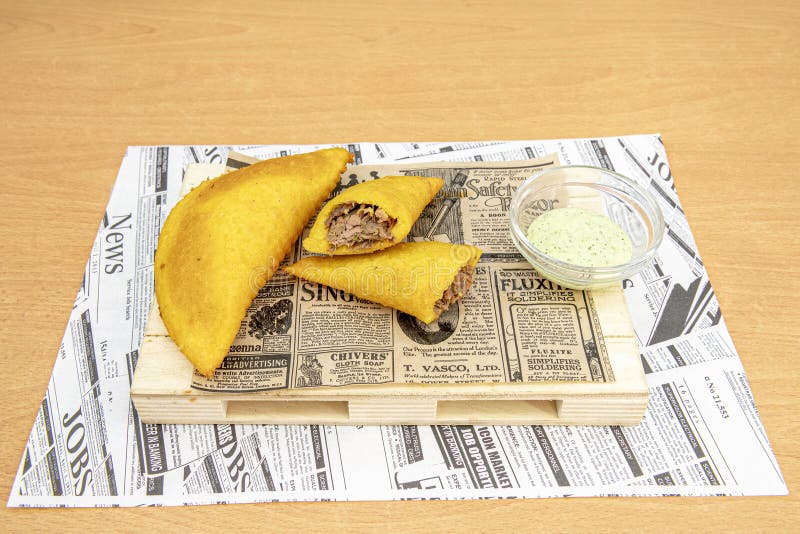 Cornmeal Dough Empanadas Stuffed with Meat with Green Sauce for Dipping