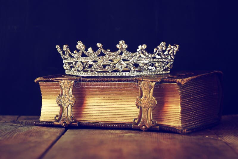 Decorative crown on old book. vintage filtered. selective focus. Decorative crown on old book. vintage filtered. selective focus.