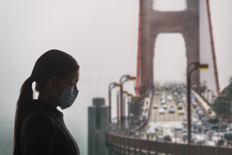 Coronavirus in California. Woman with surgical mask for corona virus covid-19 protection in San Francisco in front of stock photos Coronavirus in California. Woman with surgical mask for corona virus covid-19 protection in San Francisco in front of stock photos