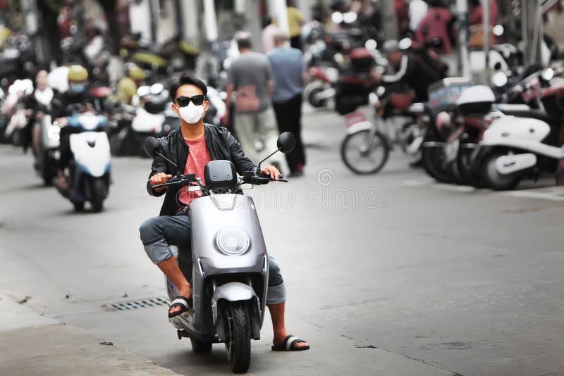 coronavirus-china-threat-epidemic-young-man-motorbike-rides-streets-city-medical-mask-his-face-health-173010866.jpg