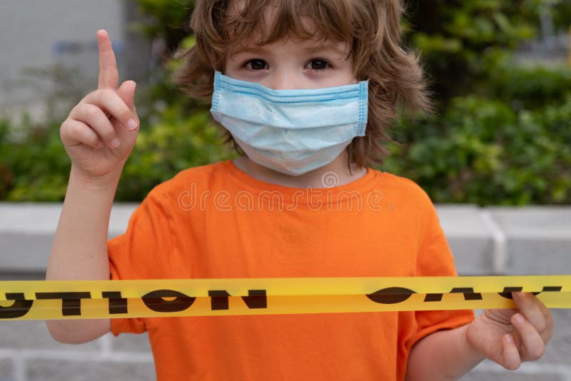 Coronavirus Covid-19. Little boy wearing face mask show sign with finger up. Stay home. Social distancing. New normal stock photos Coronavirus Covid-19. Little boy wearing face mask show sign with finger up. Stay home. Social distancing. New normal stock photos