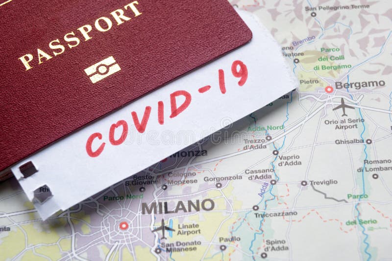 Coronavirus epidemic and travel restrictions in Italy concept. The note COVID-19 and passport on map with Milan. Novel corona