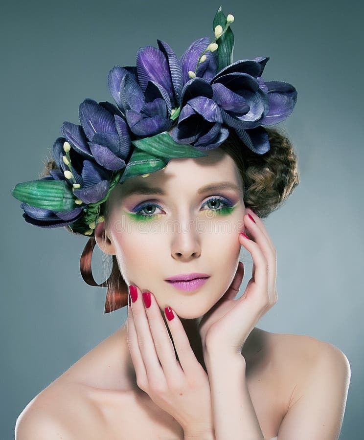 Portrait of young fine woman wearing a wreath of purple flowers. Series of photos. Portrait of young fine woman wearing a wreath of purple flowers. Series of photos