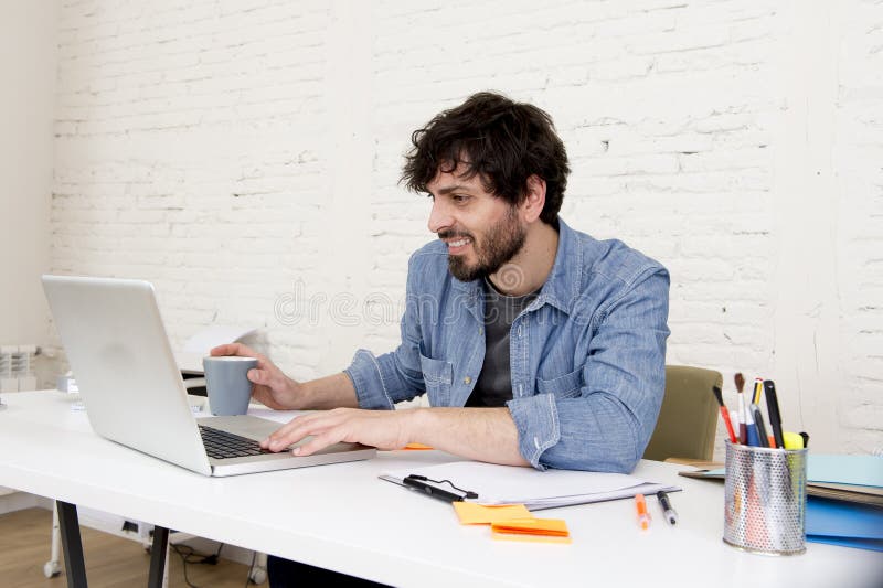 Corporate portrait young hispanic attractive hipster businessman working with computer modern home office