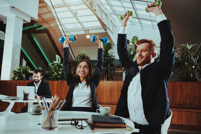 Happy Office Workers Working with Dumbbells stock image Happy Office Workers Working with Dumbbells stock image