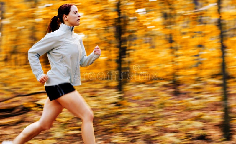 Beautiful young woman running in a fall forest. Beautiful young woman running in a fall forest.