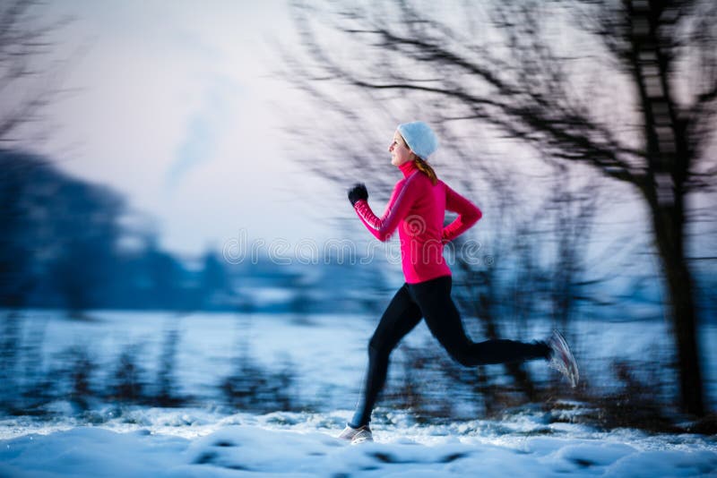 Winter running - Young woman running outdoors on a cold winter day. Winter running - Young woman running outdoors on a cold winter day