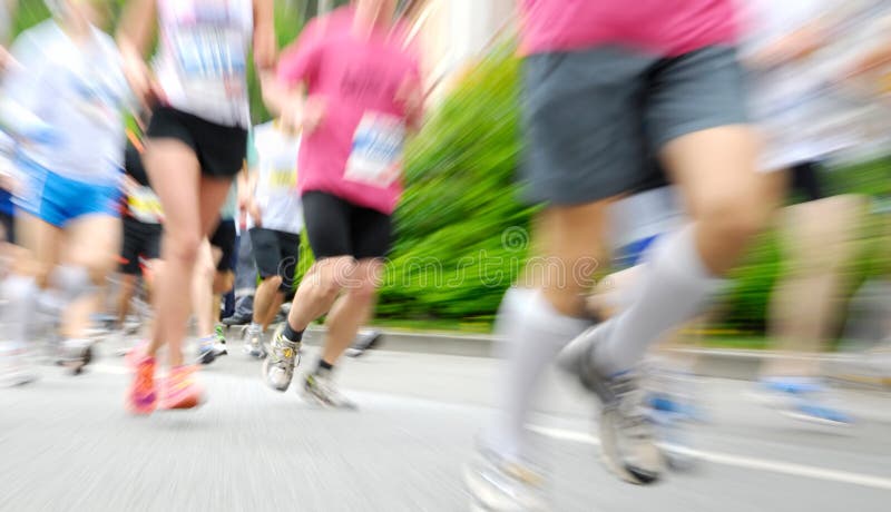 Runners at a race running on the street, with zoom effect (radial blur). Runners at a race running on the street, with zoom effect (radial blur)