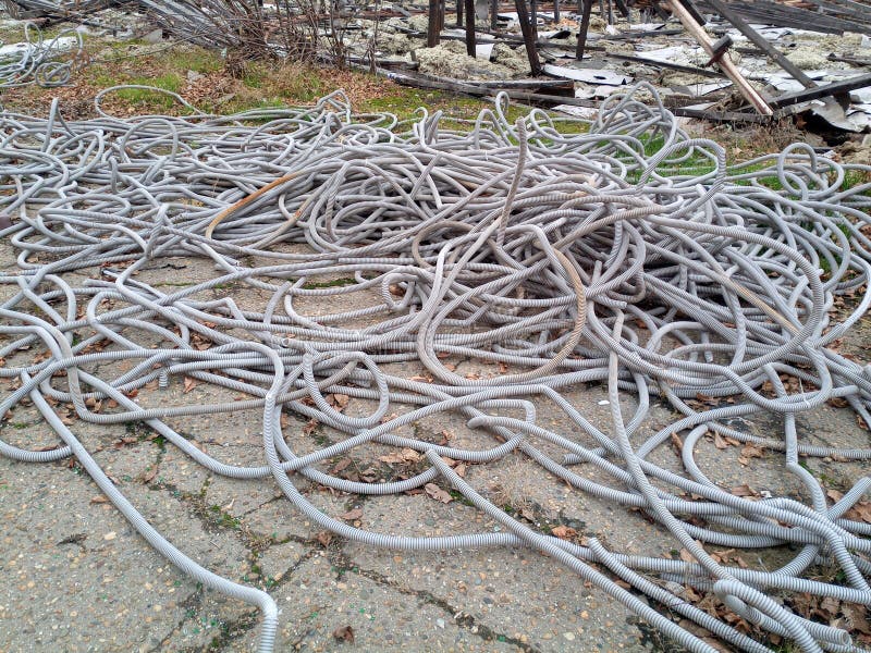 Corrugated Pipes for Electrical Wiring Lie in Heap on the Ground. Stock