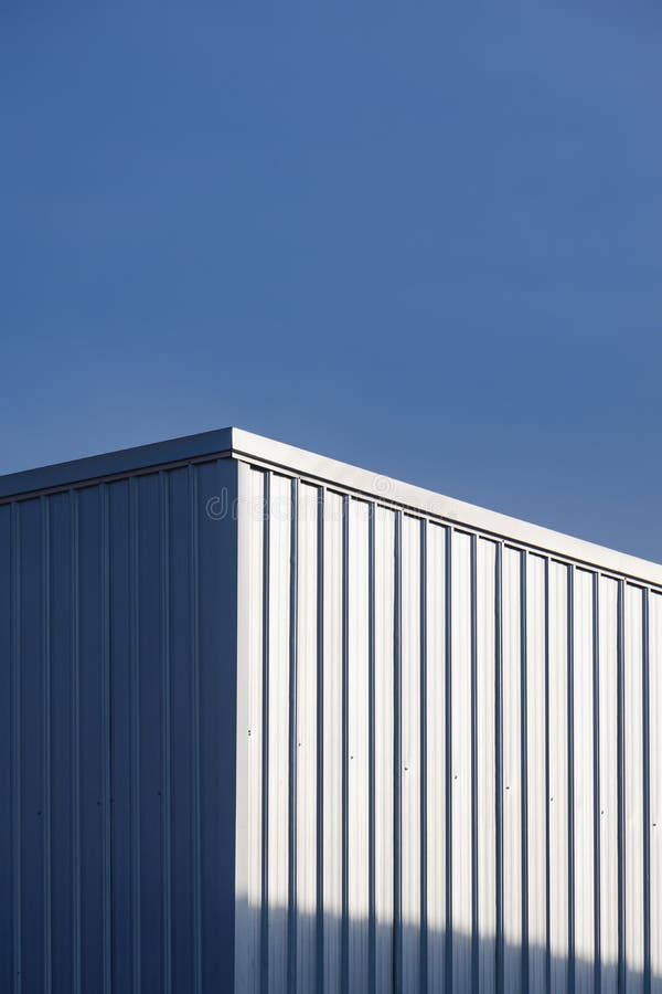 Corrugated Steel Warehouse Building Wall with Sunlight Reflection on
