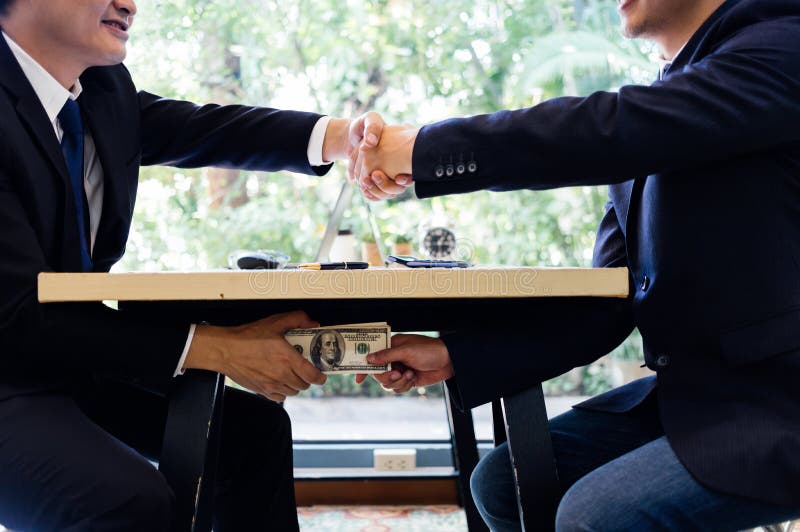 Corrupted Two Businessman Sealing the Deal with a Handshake and Receiving a  Bribe Money. Stock Photo - Image of banner, bribe: 112139242