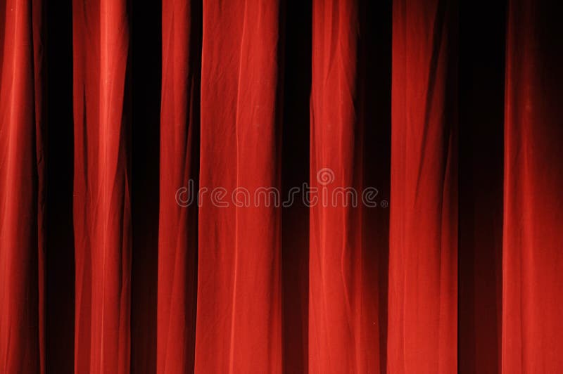 A view of a thick, rich, red theater curtain. A view of a thick, rich, red theater curtain.