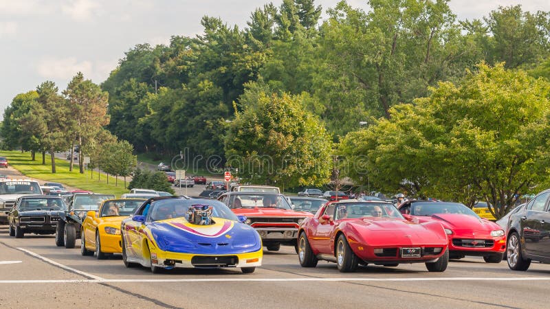 BLOOMFIELD HILLS, MI/USA - AUGUST 16, 2014: Three Chevrolet Corvettes, a Camaro, and a Pontiac GTO cars at the Woodward Dream Cruise, the world's largest one-day automotive event. Woodward is a National Scenic Byway and Michigan Heritage Route. BLOOMFIELD HILLS, MI/USA - AUGUST 16, 2014: Three Chevrolet Corvettes, a Camaro, and a Pontiac GTO cars at the Woodward Dream Cruise, the world's largest one-day automotive event. Woodward is a National Scenic Byway and Michigan Heritage Route.