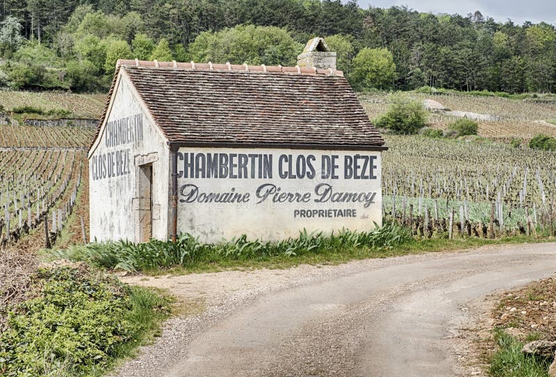 GEVREY-CHAMBERTIN, FRANCE - APRIL 23, 2018: A small barn or farm outbuilding is located by the side of the road in the Clos de Beze grand cru vineyard near Gevrey-Chambertin in France. GEVREY-CHAMBERTIN, FRANCE - APRIL 23, 2018: A small barn or farm outbuilding is located by the side of the road in the Clos de Beze grand cru vineyard near Gevrey-Chambertin in France.