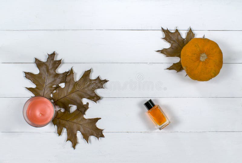 Cosmetic flatlay with beauty product, candle and pumpkin with leaves on a wooden background. royalty free stock image Cosmetic flatlay with beauty product, candle and pumpkin with leaves on a wooden background. royalty free stock image