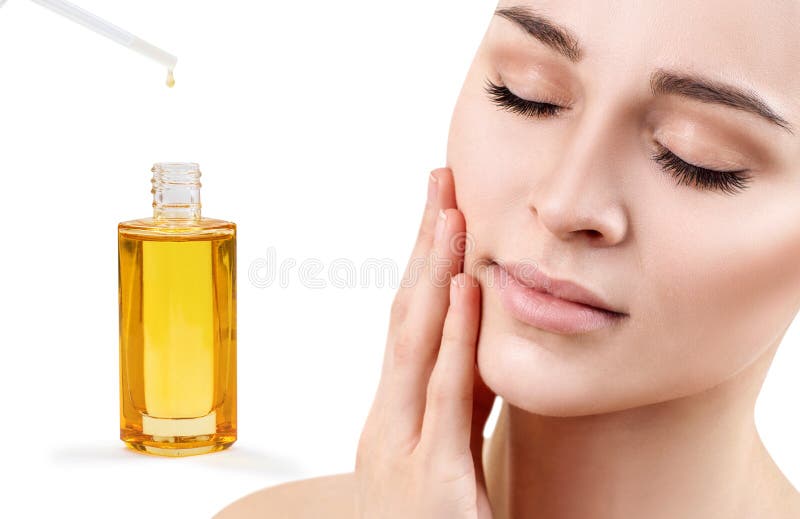 Cosmetic oil applying on face of young woman. royalty free stock photography Cosmetic oil applying on face of young woman. royalty free stock photography