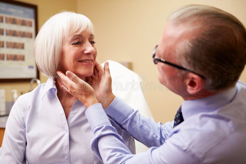 Cosmetic Surgeon Examining Senior Female Client In stock photography Cosmetic Surgeon Examining Senior Female Client In stock photography